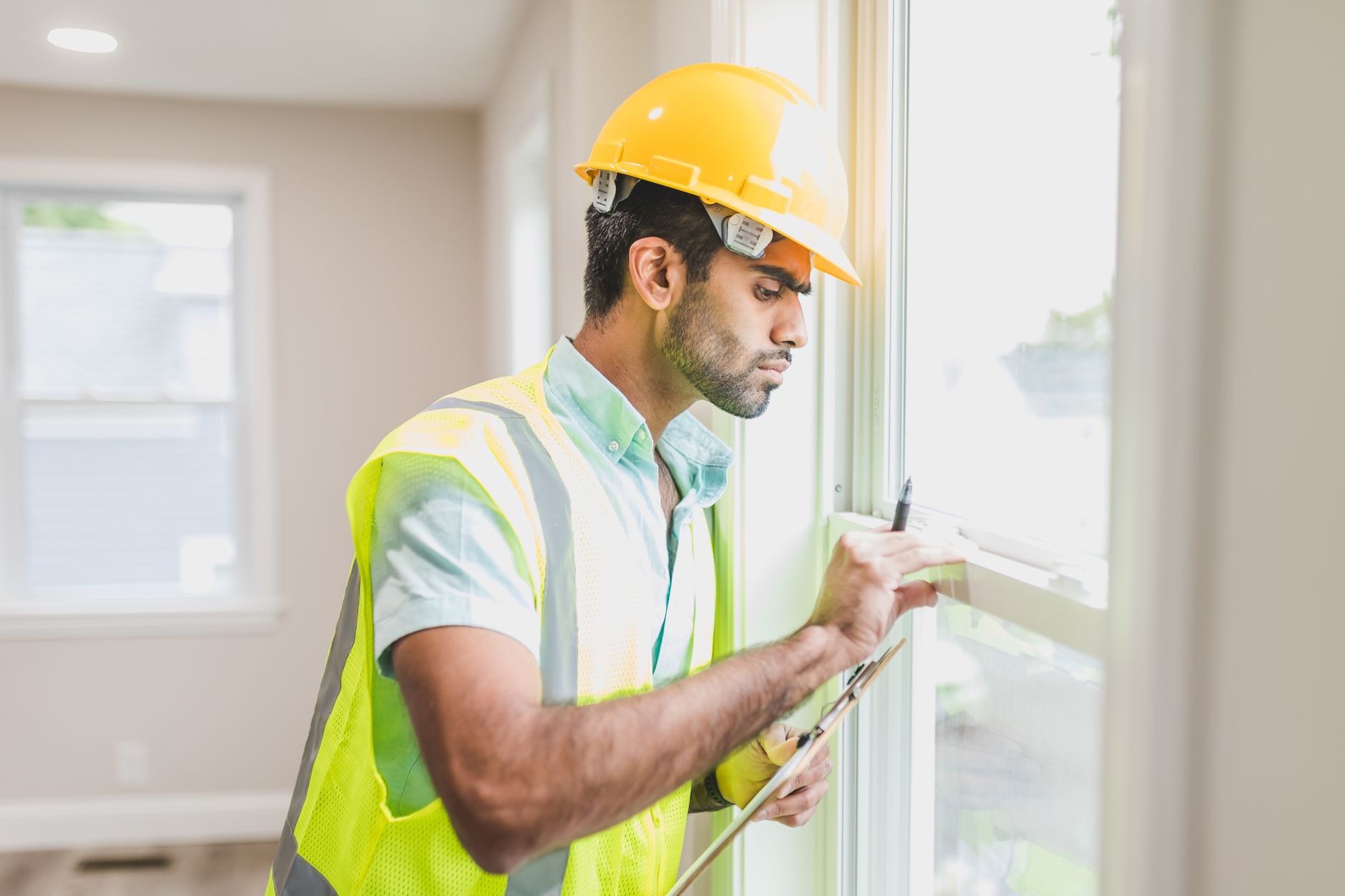 Contractor inspecting a window during a residential remodel