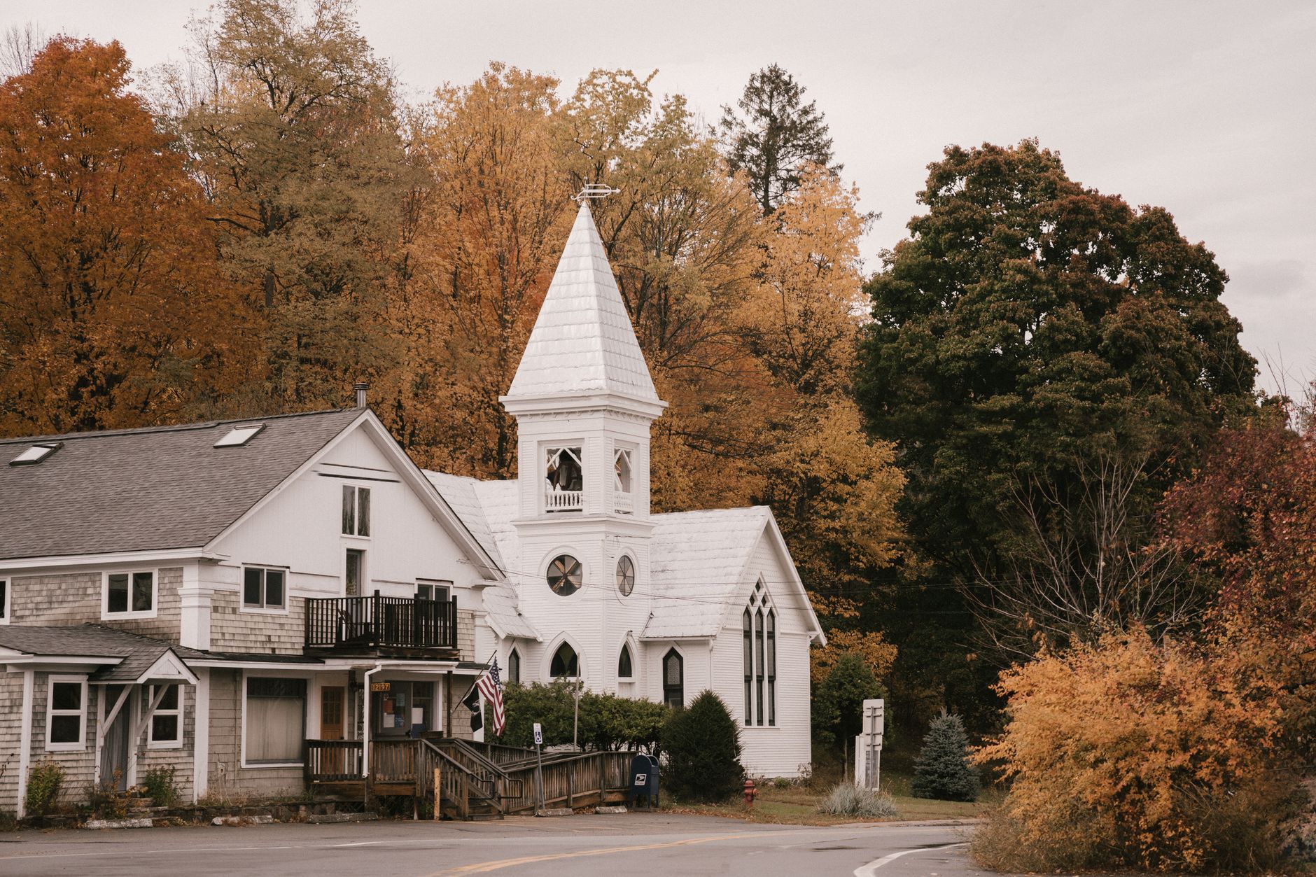 A quiet New England town center with a white church steeple